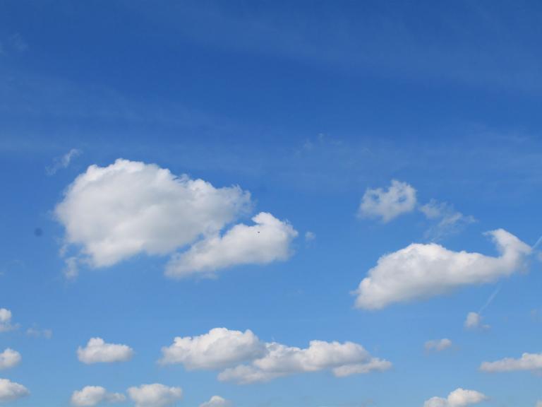 Zu sehen ist ein blauer Himmel mit leichter Bewölkung